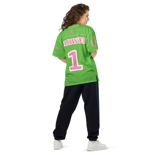 Woman wearing Yahweh Christian football jersey in bright green with pink accents and number 1.