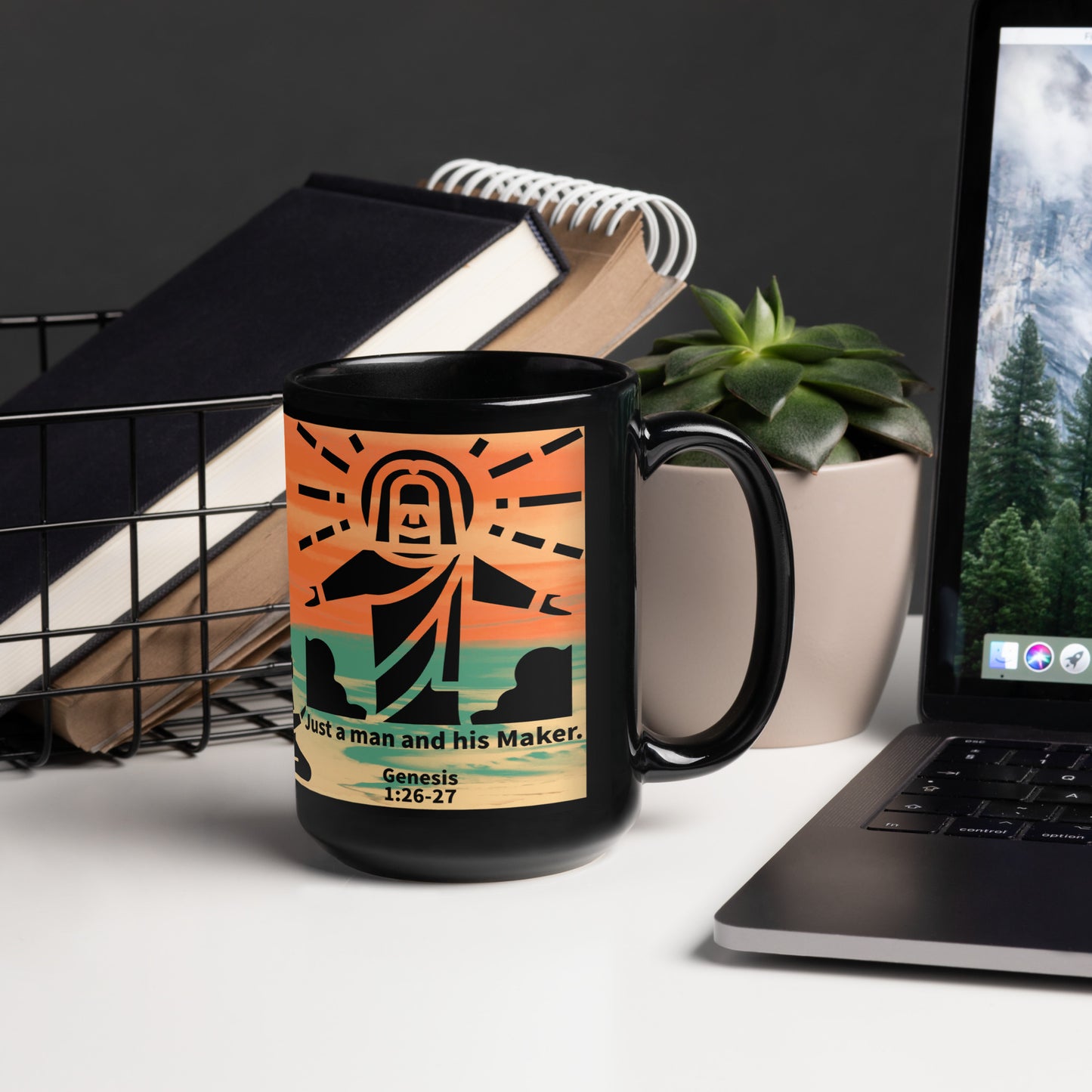 orange and black mug with a man and Jesus image sitting on a table next to a laptop