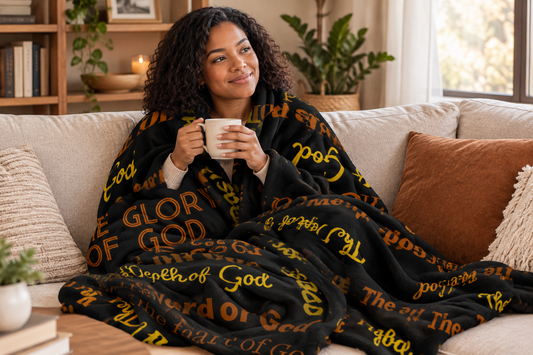 Adult wrapped in the Attributes of God throw blanket at home