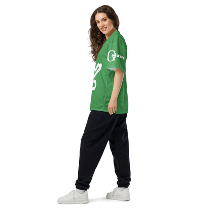 Woman wearing a green Yahweh Christian football jersey styled with black pants, showcasing a casual look.