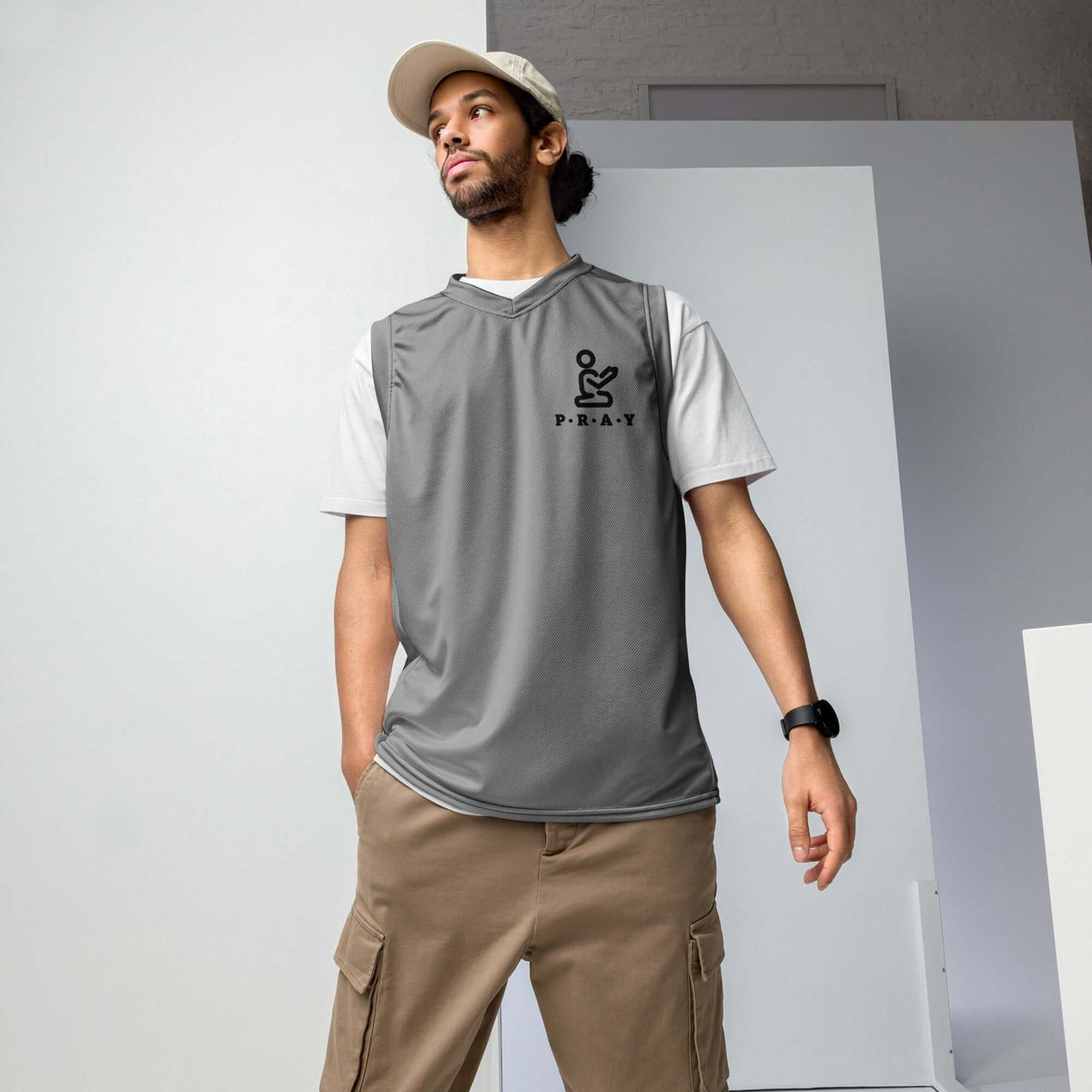 Man wearing Pray Christian Grey Recycled Mesh Basketball Jersey with logo, perfect for sports and casual style.