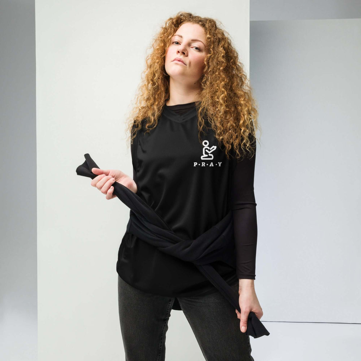 Model wearing a Pray Christian black mesh basketball jersey with two-way stretch for comfort and style.