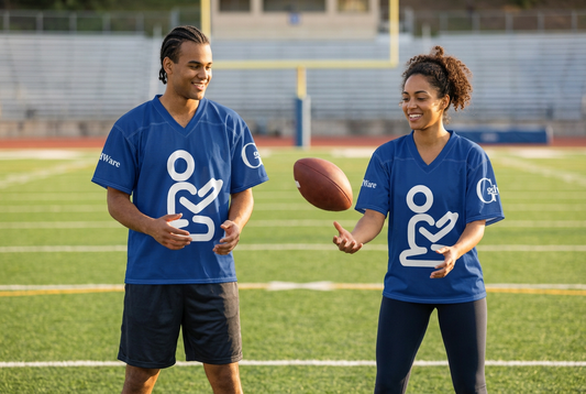 Man and woman wearing the GodWare jersey while tossing a football