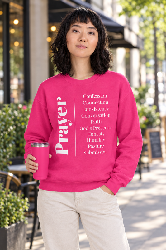 Model wearing the heliconia sweatshirt and holding a hot pink tumbler